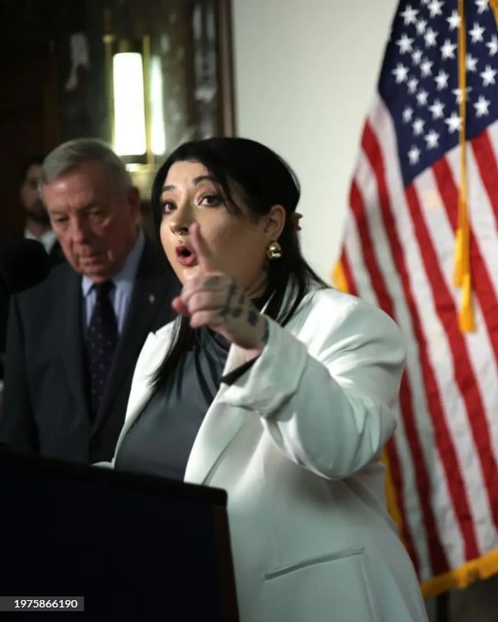 Leah speaking alongside U.S. Senator Dick Durbin at the Senate Judiciary Committee press conference on regulating Big Tech in Washington, DC (2024) Courtesy Leah Juliett.