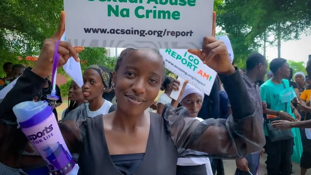 ACASI youth with banner