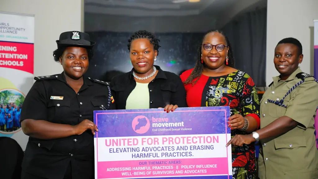 Four Black advocates holding a purple banner that reads "United for Protection: Elevating Advocates and Erasing Harmful Practices".