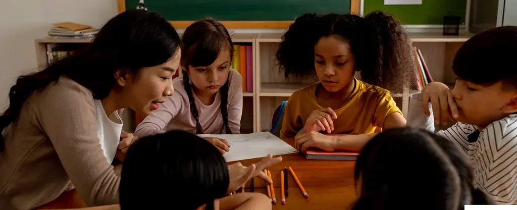 A group of children of diverse ethnicities sitting at a desk, intently reading a book together.